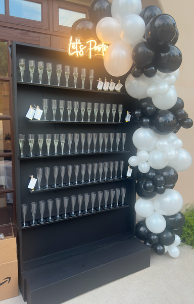 Black solid shelf champagne wall with balloon arch